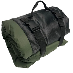 A rolled outdoor sleeping dog bed in olive green and black, secured with black straps and a carry handle, photographed on a plain light background.