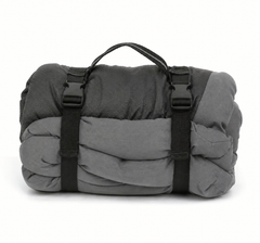 A rolled up dog bed in grey